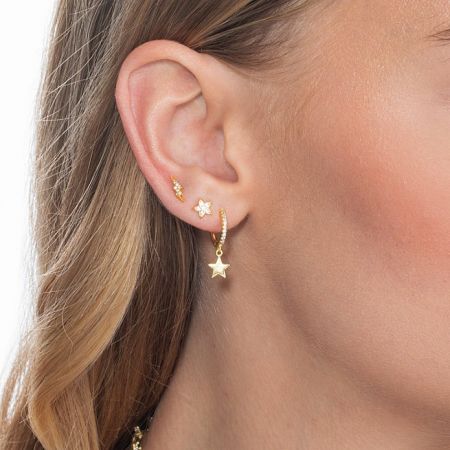 A detailed close-up view of the gold star and cubic zirconia stud earrings, highlighting the fine craftsmanship.