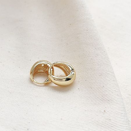 Detailed product view of the gold vintage circle teardrop hoop earrings.