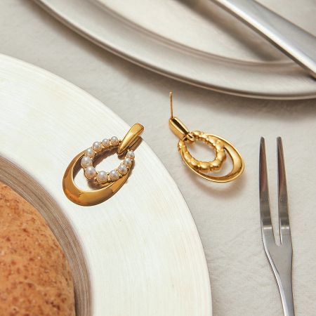 Lifestyle view of the non-tarnish pearl earrings in a sophisticated table setting.