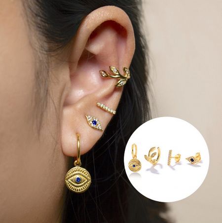 Close-up of the gold evil eye earring with a central blue cubic zirconia.