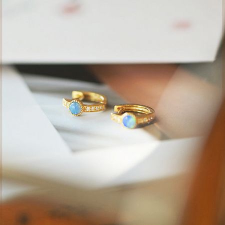 Detailed view of the 925 sterling silver mini hoop earrings, highlighting the vibrant blue opal and sparkling zircon details.