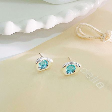 A pair of sterling silver stud earrings with brilliant blue opal stones.