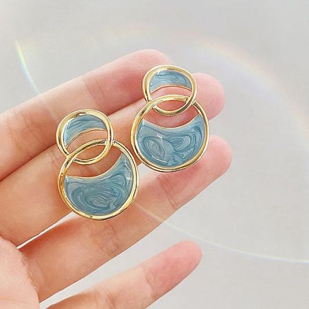 Hollow-out 14k gold plated stud earrings featuring elegant blue enamel interlocking circles.