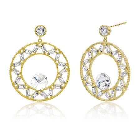 Close-up shot of the gold dangle earrings, showcasing the large central stone surrounded by smaller clear gemstones.