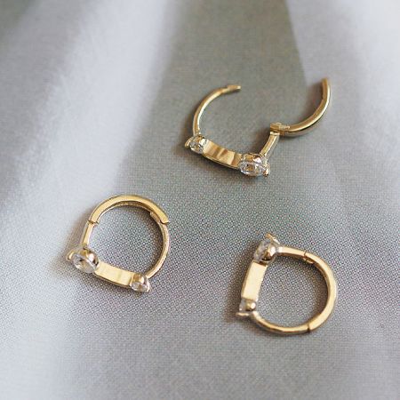 An assortment of the sterling silver zircon huggie earrings from the five-pair set.