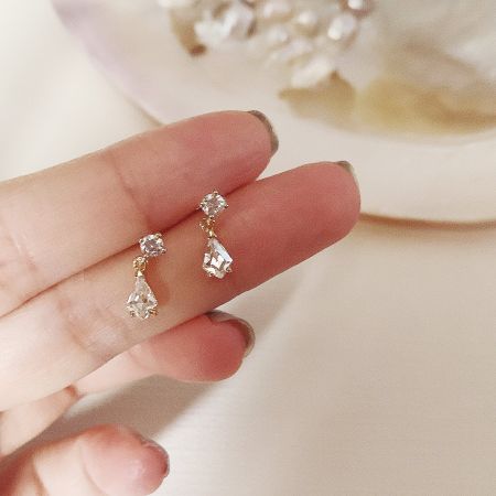 A detailed studio shot of the gold-plated sterling silver water drop crystal earrings against a neutral background.