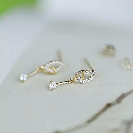 Full view of the women's minimalist 14K gold plated leaf mini drop earrings.