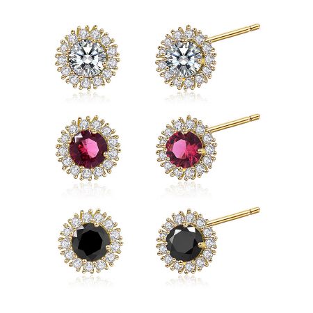 A collection of gold-plated stud earrings with clear, pink, and black gemstones, each surrounded by a halo of smaller diamonds.