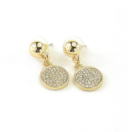 Angled shot of the gold earrings with sparkling crystal pendants.