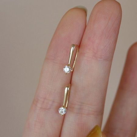 A pair of 14K gold plated sterling silver hook earrings with crystal details shown against a neutral background.