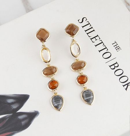 Close-up of the gold-plated tear drop earrings showcasing the gemstone details.