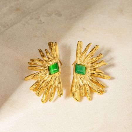 A pair of gold earrings with green gemstones in an abstract flower-like design.