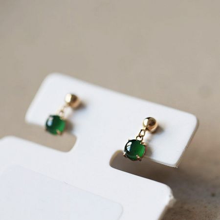 Clean product shot of the tiny jade earrings on a white background.