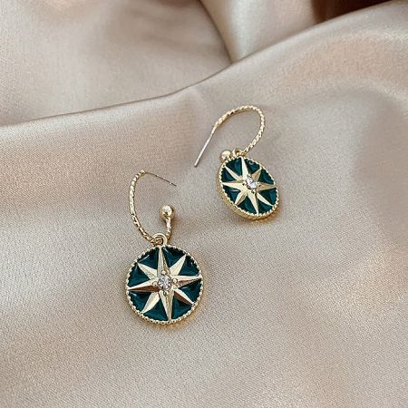Angled shot of the vintage art deco earrings highlighting the starburst design.