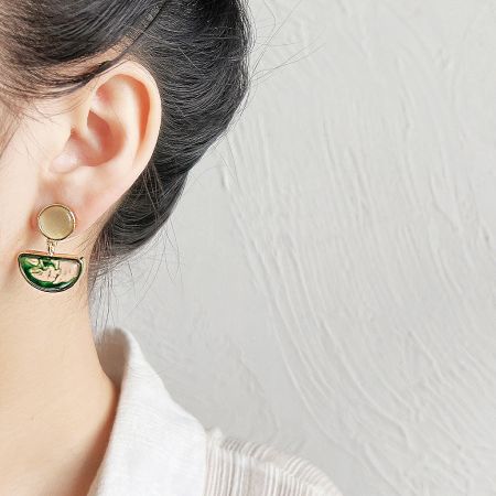 Vintage-style gold earrings with a circular top and a green stone inlay.