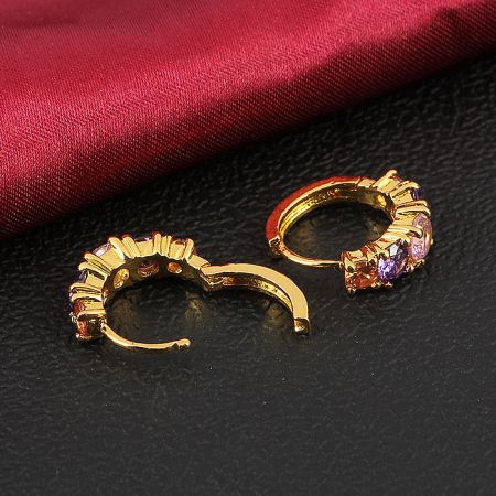 A pair of gold hoop earrings displaying a full spectrum of multicolored gemstones.