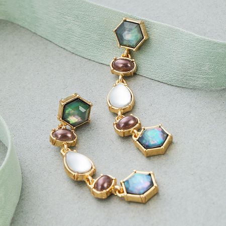Full view of the gold vintage earring displaying the intricate arrangement of multicolored gemstones.