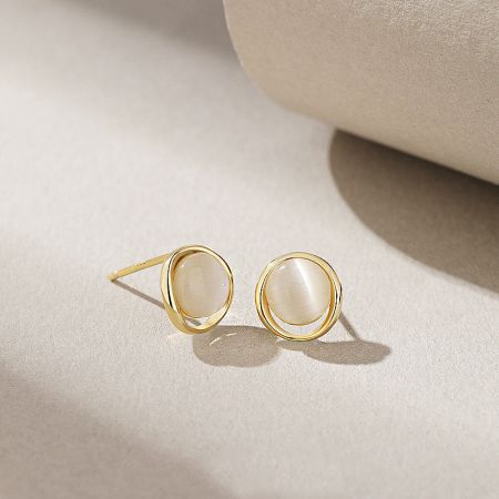 Detailed view of the gold-plated cat-eye stone stud earrings, showing the delicate frame and gemstone.