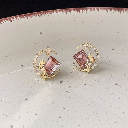 Detailed view of the 14k gold-plated celestial stud earrings, showcasing the star and moon designs.