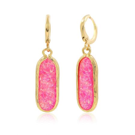 Detailed shot of the pinky resin earring showcasing the textured gold border and marbled pink stone.