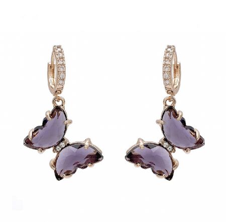Purple Butterfly Huggie Earrings - Close-up of the Purple Butterfly Huggie Earrings (JRE-113), showcasing the detailed gold-plated brass, sparkling purple crystal, and white cubic zirconia accents.