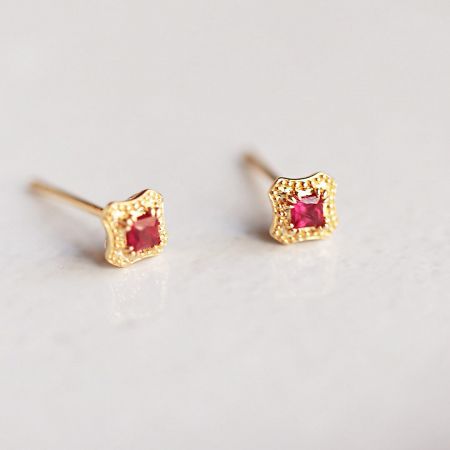 Detailed shot of the vintage 925 sterling silver stud earrings with a textured gold finish.