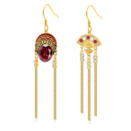 Close-up detail of the Chinese Opera Mask earring, showing intricate gold work, red and white gemstones, and delicate dangling chains.