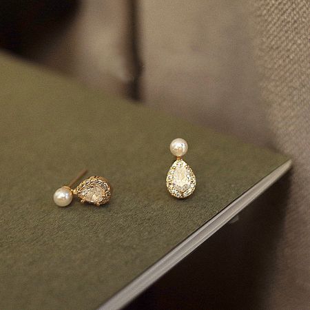 Detailed view of the water drop earrings, highlighting the brilliant zircon and smooth pearl.