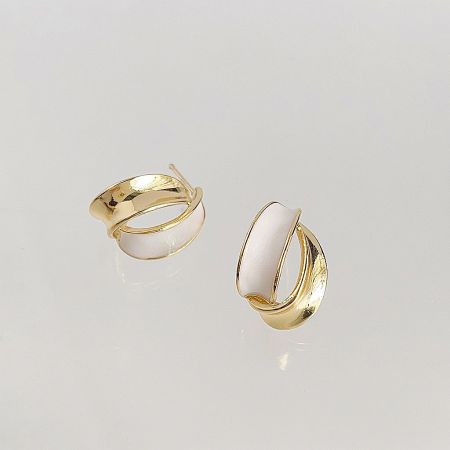 Detailed shot of the gold hoop-style earrings with a clean white inlay, part of the five-pair set.