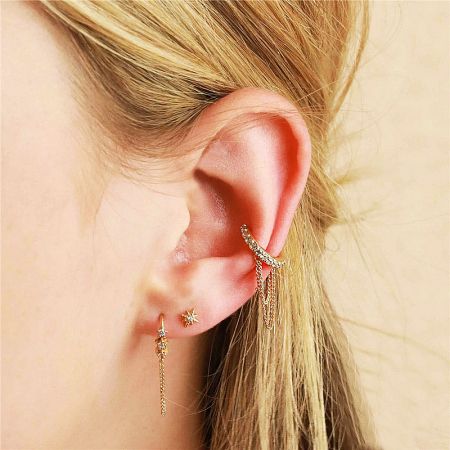 Gold variant of the double-layer chain tassel ear clip earring shown on a model's ear.