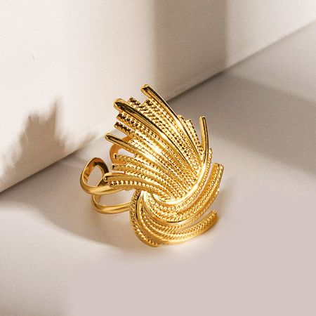 Detailed view of a gold ring with a textured, feather-like design.