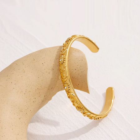 Another view of the celestial-themed gold bracelet showcasing its floral details.