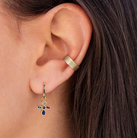 Cross hoop earring shown on an ear for scale and style.