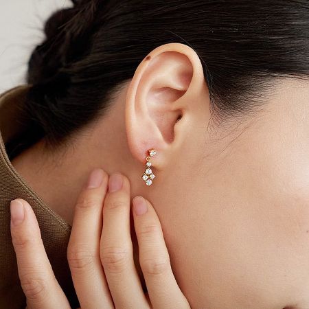 18k Gold Plated Minimalist French Vintage 925 Sterling Silver Cubic Zirconia Earring Set (5 Pairs) - Close-up of a woman wearing an 18k gold plated 925 sterling silver floral earring with cubic zirconia, part of a minimalist French vintage set.