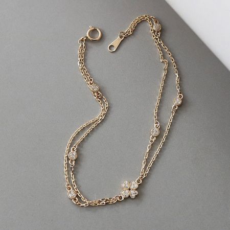 Another angle of the lucky four-leaf clover bracelet, highlighting its layered design and brilliant finish.