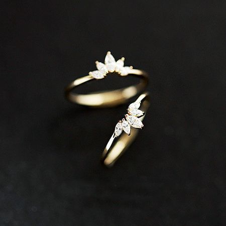 Two gold-plated sterling silver flower rings displayed side-by-side to highlight the intricate design details.