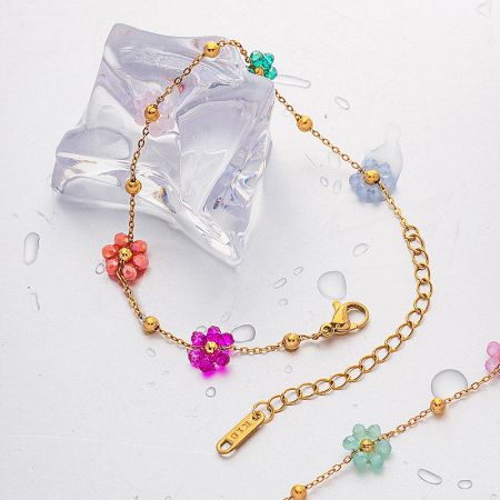 Another design from the set, a gold bracelet featuring flower beads in various pastel colors.