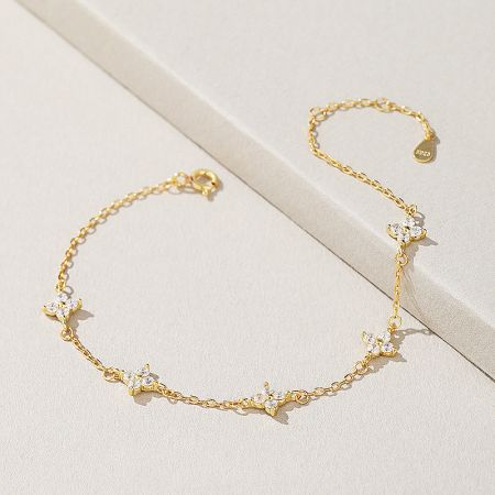 Close-up of the intricate four-leaf clover charm with shimmering zircon stones.