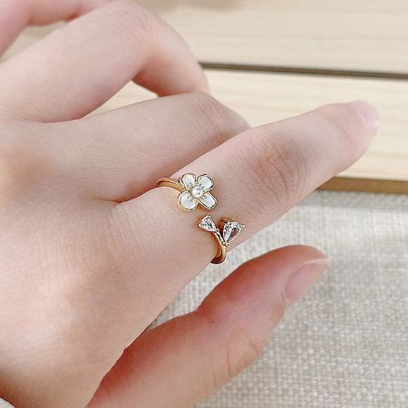14k Gold Plated Brass White Enamel Flower with Pearl and Zircon Open Finger Rings Set of 5 - A detailed close-up of a 14k gold-plated brass ring from a set of five, featuring an intricate white enamel flower and butterfly design with zircon accents.