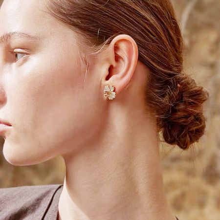 Detailed view of a single 18K gold-plated flower stud earring.