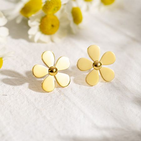 Detailed view of the gold daisy flower stud earrings, showing the intricate petal and center details.