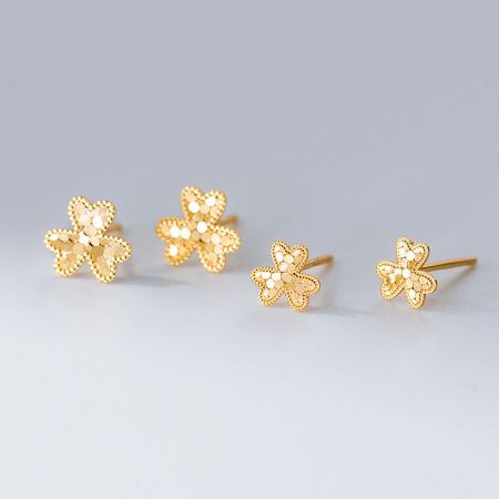 A pair of elegant gold-plated flower stud earrings made from 925 sterling silver with intricate laser-cut details.