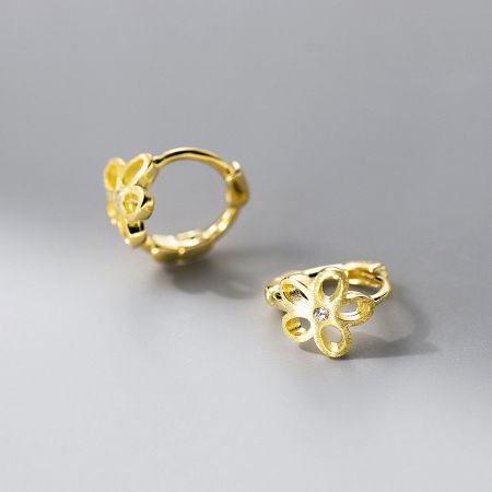 Detailed view of the gold-plated flower huggie hoop earrings.
