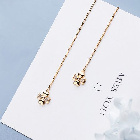 The Four Leaf Clover earrings presented on a stylish display card, perfect for gifting.