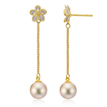 Side view of the gold flower earrings showcasing the pearl drops and clear stone details.