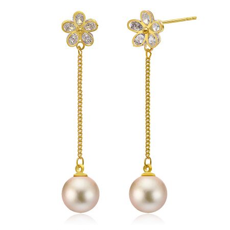 Close-up of the gold flower earring with five clear gemstones and a pale pink pearl.