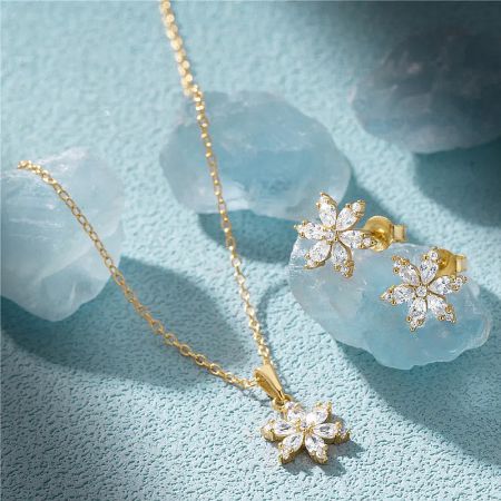 The snowflake jewelry set in a luxurious gold finish, showcasing the intricate design and clear gemstones.