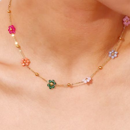 Close-up of the colorful flower-shaped beads on the gold stainless steel chain.