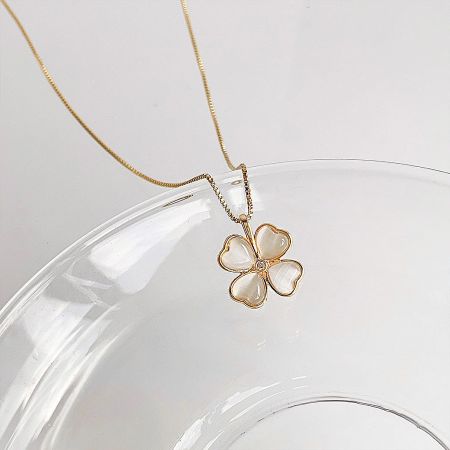 Gold Plated Rhinestone & Cat-Eye Opal Pendant Necklace Set (5 Pieces) - A gold-plated necklace from a 5-piece set, featuring a flower pendant with white cat-eye stone heart-shaped petals and a central rhinestone.