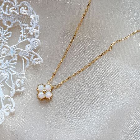 Another angle of the minimalist clover opal necklace, highlighting its delicate design.